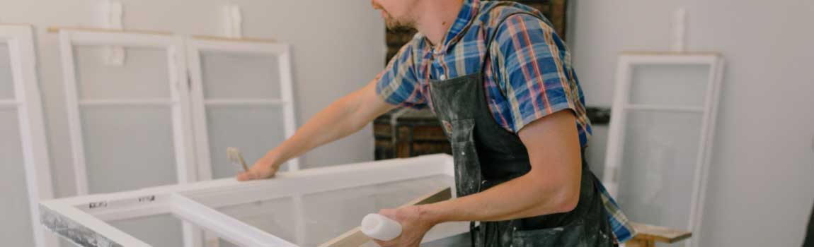 A person preparing a window for installation.