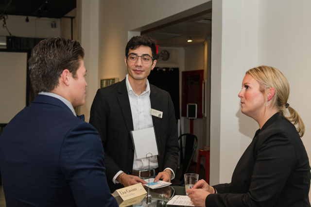 Jaret Warstler and Marcelo Ketzler-Lopez conversing with Lisa Cassino at the KPMG Etiquette Dinner