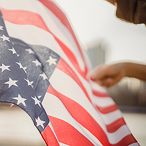 American flag being held by one hand