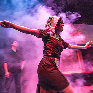 Student actress on a purple pink misty stage