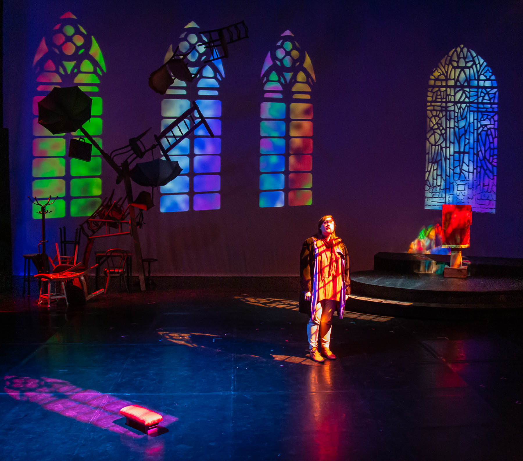 Stained glass and stacked chairs set built for "Dead Man's Cell Phone." UAF Photo